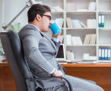 Ofiste çalışan genç bir işadamı.