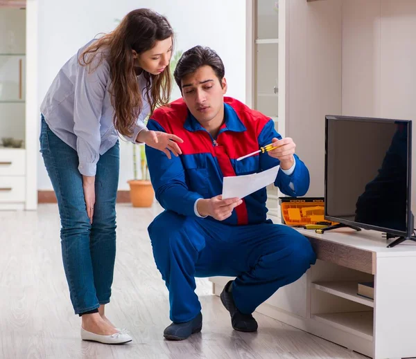 Repairman repairing tv at home