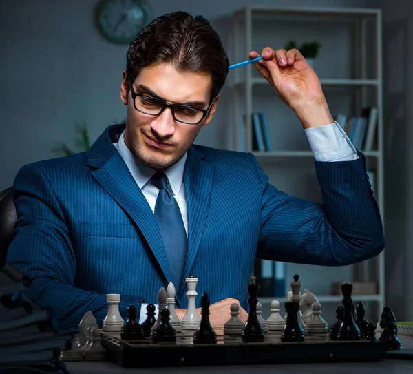Businessman playing chess in strategy concept — Stock Photo, Image
