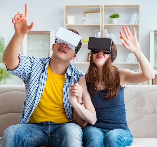 The young family playing games with virtual reality glasses
