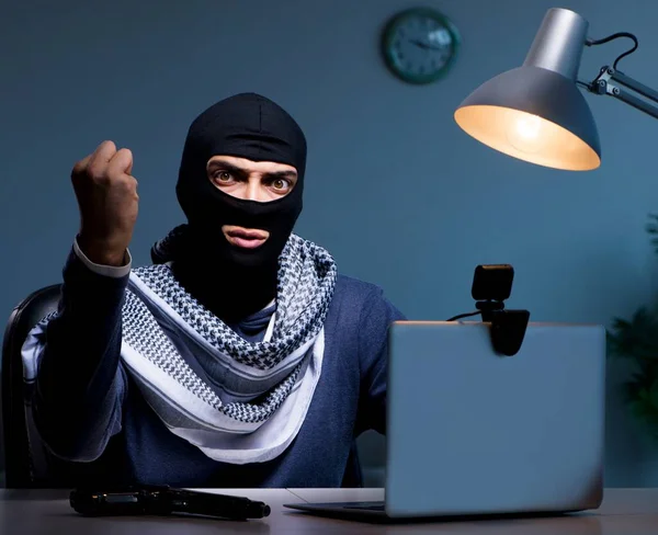 Hacker wearing balaclava mask hacking computer — Stock Photo, Image