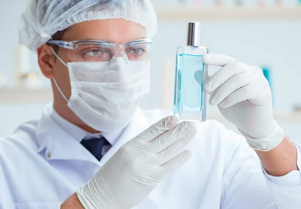 Chemist mixing perfumes in the lab