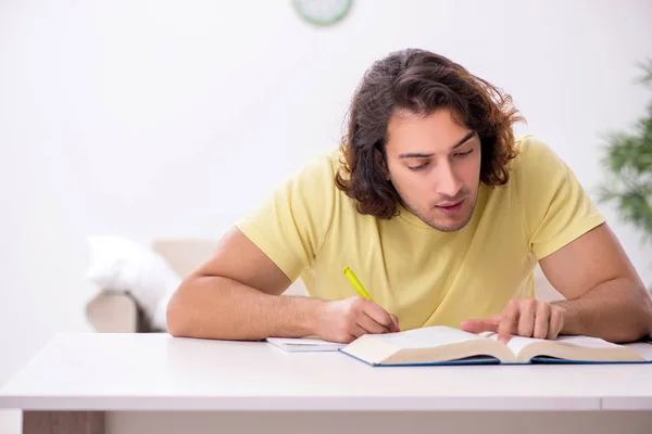 Young male student preparing for exams at home Stock Image