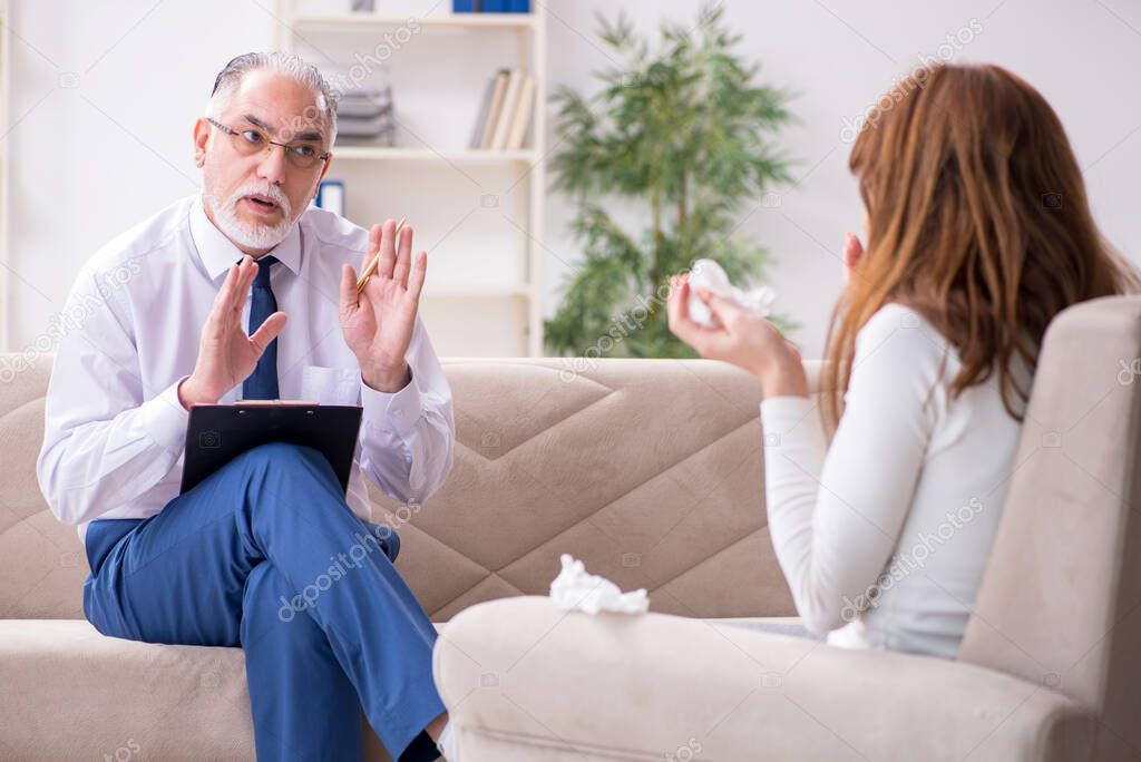 Young woman visiting old male doctor psychologist