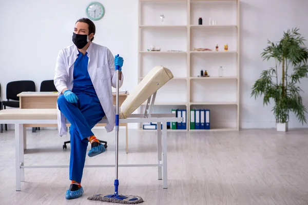 Genç erkek müteahhit salgın konseptinde dezenfekte kliniği
