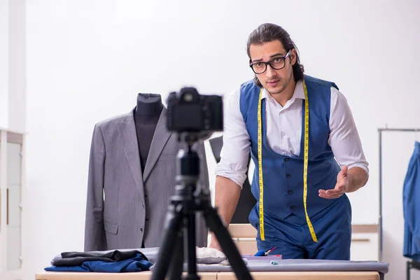 Young male tailor recording video for his blog