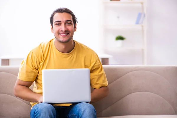 Young handsome man with computer at home — Stock Photo, Image