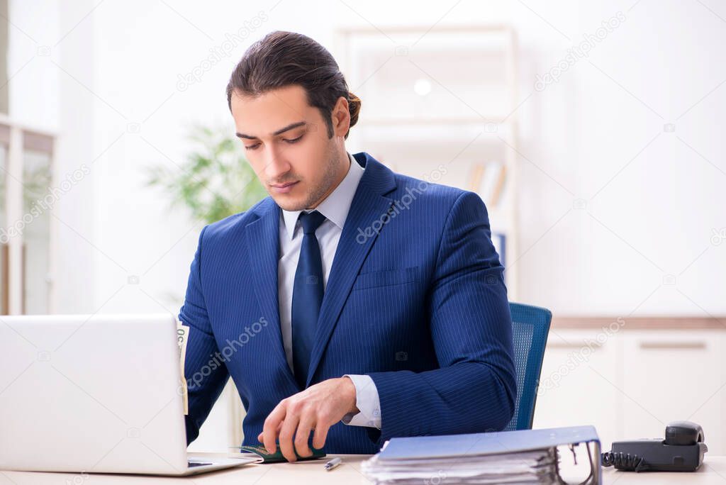 Young man checking passport in the office