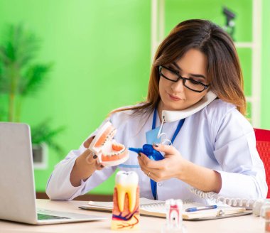 Diş implantı üzerinde çalışan kadın dişçi.