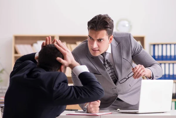 Angry boss shouting at his employee