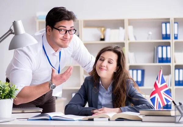 Teacher explaining to student at language training — Stock Photo, Image