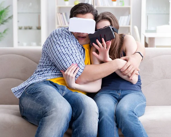 Young family playing games with virtual reality glasses