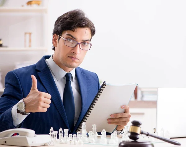 Young lawyer playing chess to train his court strategy and tacti