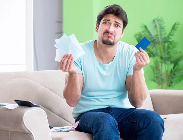 Young man struggling with personal finance and bills — Stock Photo, Image