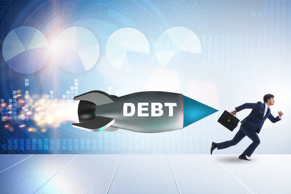 Begreppet lån och skuld med affärsman jagad av raket — Stockfoto