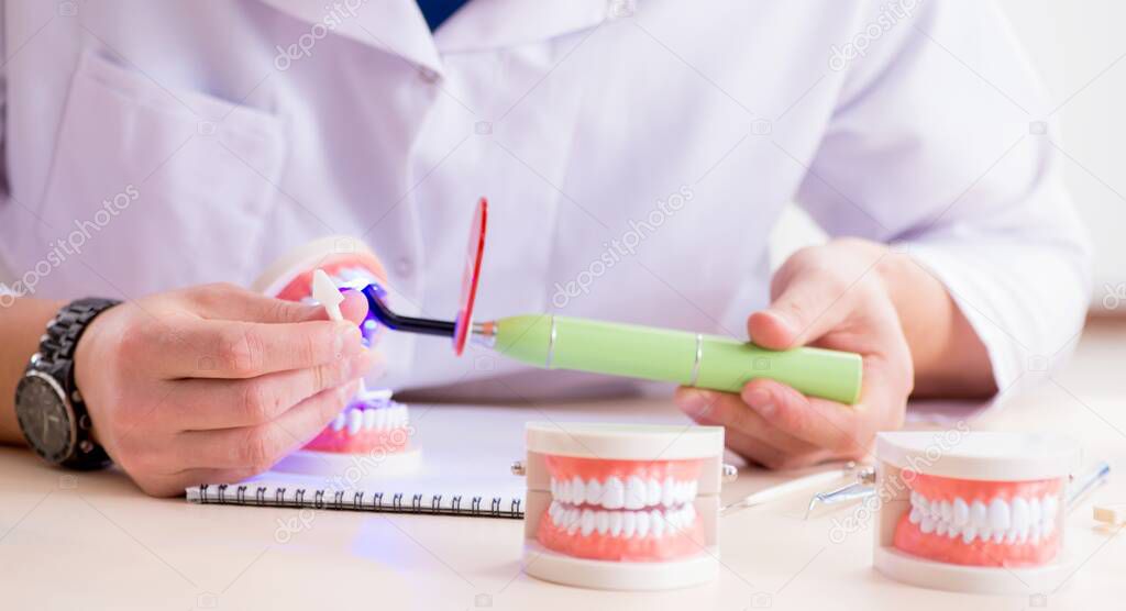 Dentist working teeth implant in medical lab