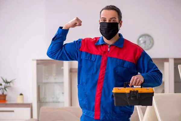 Young carpenter working indoors during pandemic disease — Stock Photo, Image