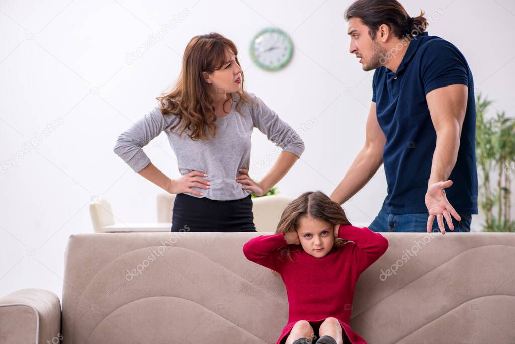 Young couple and their daughter in family conflict concept