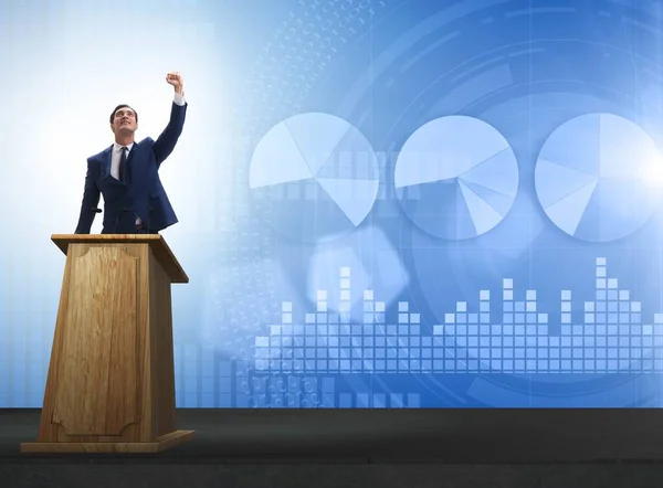 Hombre de negocios haciendo discurso en la tribuna en el concepto de negocio — Foto de Stock