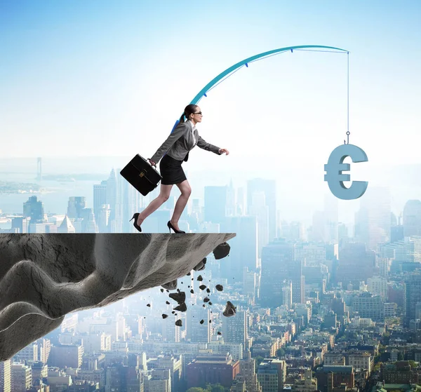 Businesswoman chasing money on fishing rod — Stock Photo, Image