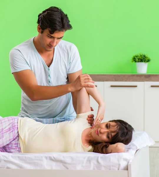 Man doing massage to his wife in bedroom — Stock Photo, Image