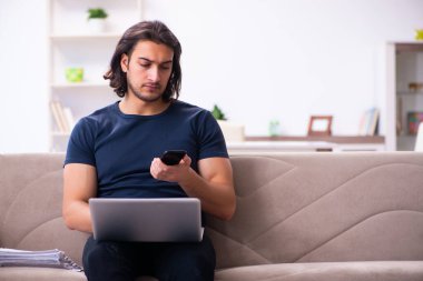 Evden çalışan genç bir adam.