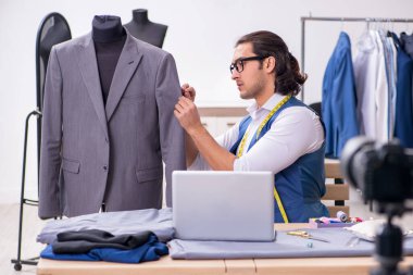 Genç erkek terzi blogu için video kaydediyor.