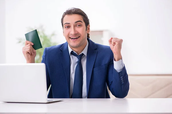 Young businessman holding passport preparing for trip — Stock Photo, Image