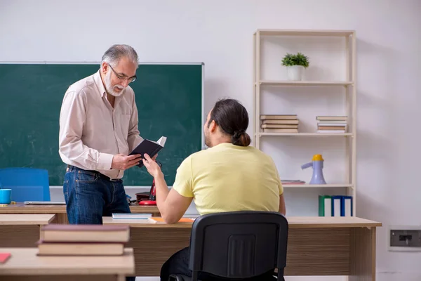 Oude leraar en jonge mannelijke student in de klas — Stockfoto