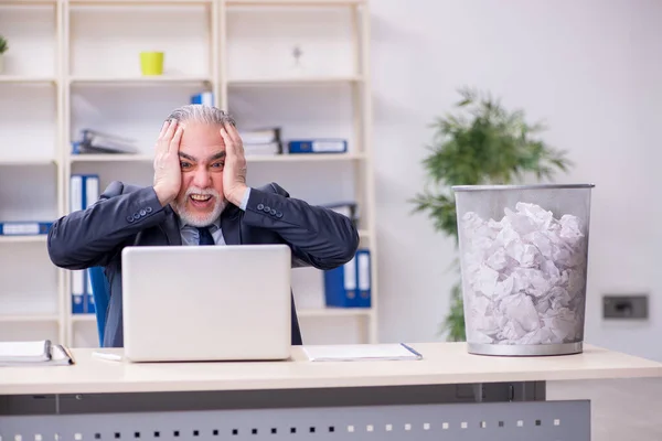 Old businessman rejecting new ideas with lots of papers — Stock Photo, Image