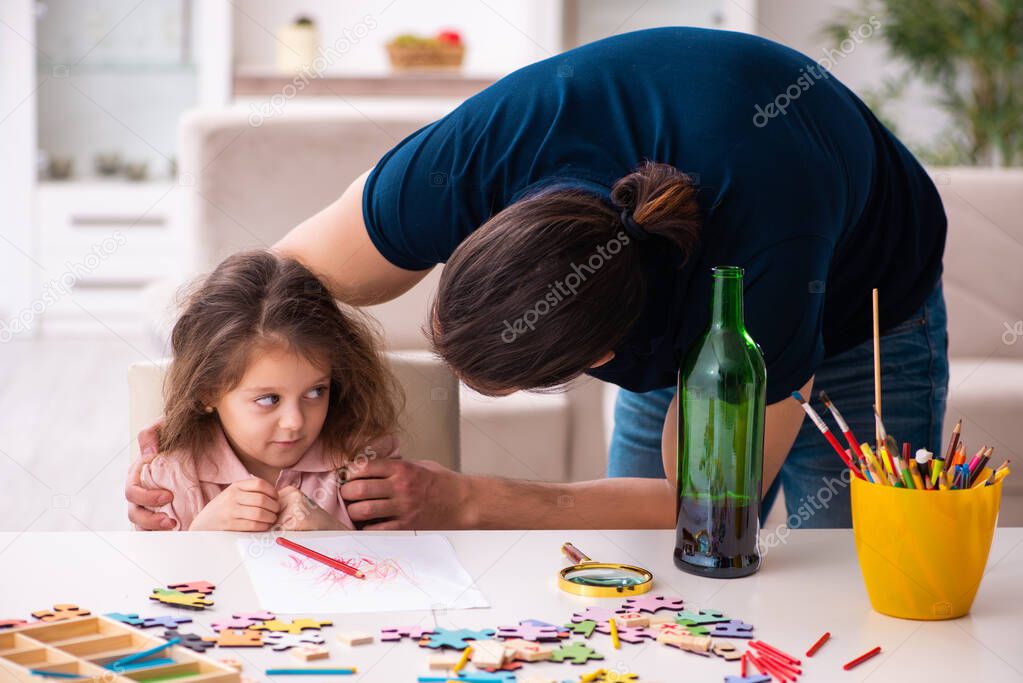 Drunk father and little girl indoors