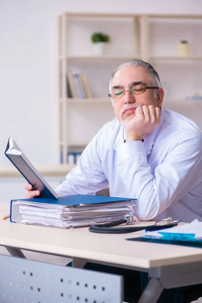 Vieux médecin masculin travaillant à la clinique — Photo