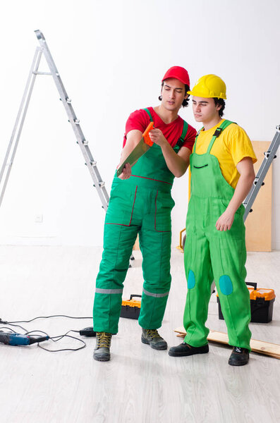 Two workers contractors working indoors