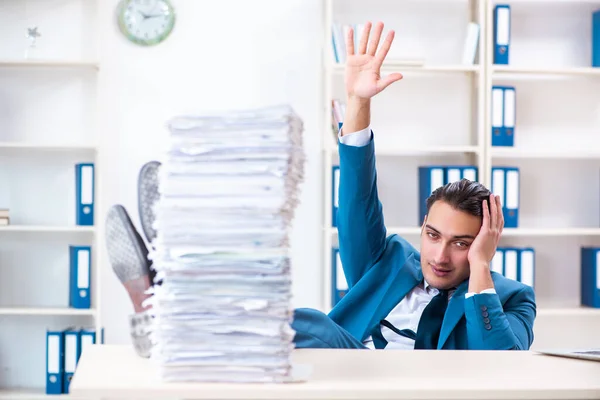 Young male employee unhappy with excessive work — Stock Photo, Image