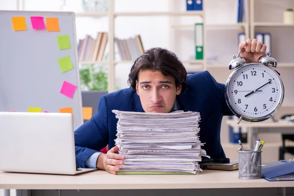 Young male employee unhappy with excessive work — Stock Photo, Image