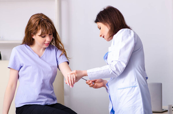 Young woman visiting female doctor physiotherapist