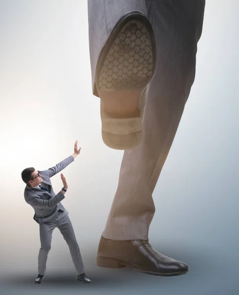 Bad angry boss kicking employee in business concept — Stock Photo, Image