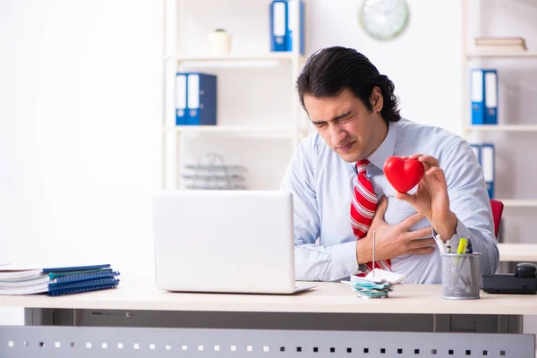 Young male employee suffering in the office — Stock Photo, Image