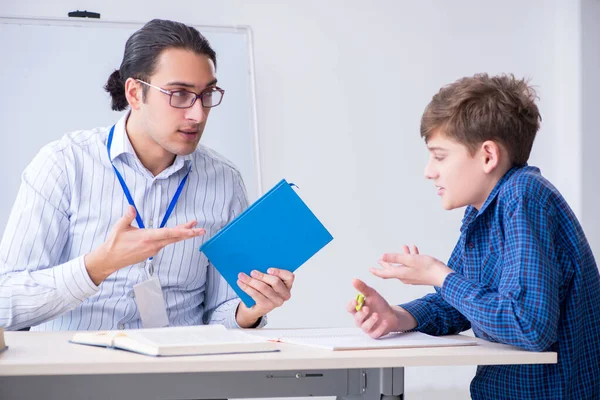 Young male teacher and boy in the classroom — Stock Photo, Image