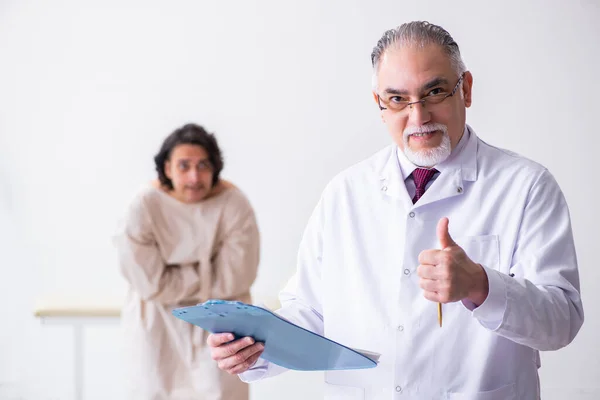 Aged male doctor psychiatrist examining young patient