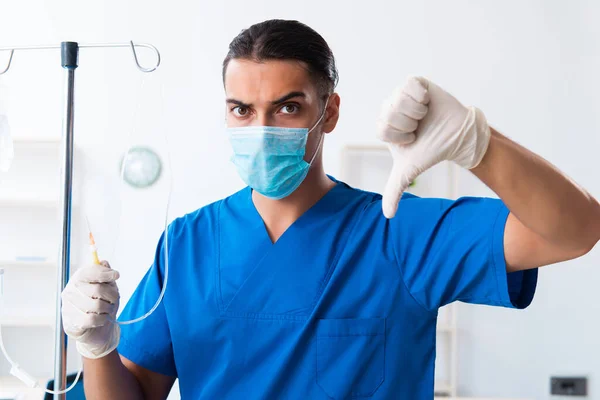 Young male doctor working in the clinic — Stock Photo, Image