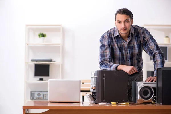 Mladý inženýr opravuje hudební hi-fi systém — Stock fotografie