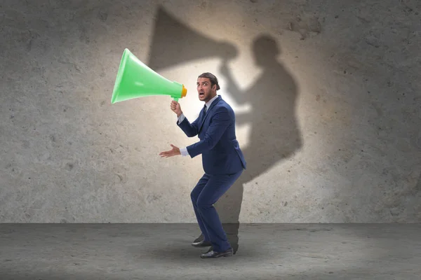 Businessman shouting through large loudspeaker — Stock Photo, Image