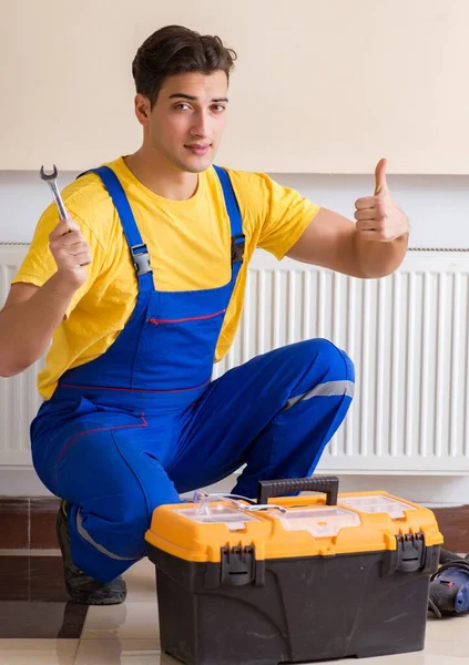 Young repairman contractor repairing heating panel — Stock Photo, Image