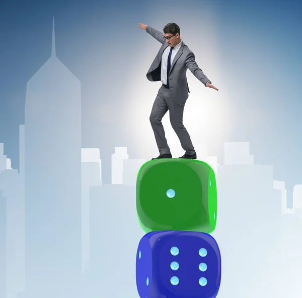 Businessman balancing on top of dice stack in uncertainty concep — Stock Photo, Image