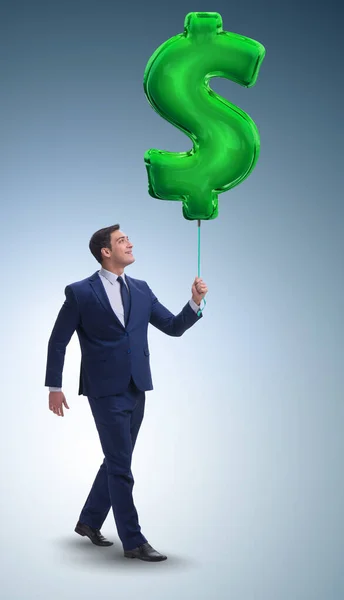 The businessman walking with inflatable dollar sign — Stock Photo, Image