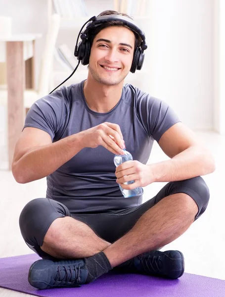 Man doing sports at home and listening to music