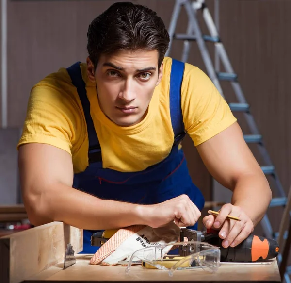 Worker working in repair workshop in woodworking concept — Stock Photo, Image