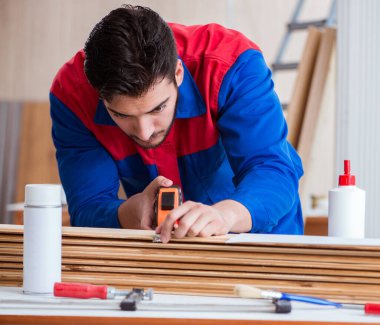 Yooung marangoz boyayla uğraşıyor.