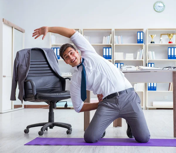 Businessman doing sports at his office space — Stock Photo, Image